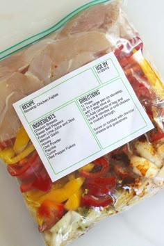 a bag filled with meat and vegetables on top of a white countertop next to a sign that says recipe ingredients