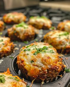 a muffin tin filled with lots of cheese and other toppings on top of it