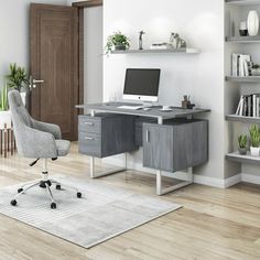 a desk with a computer on it in a room