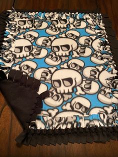 a blue and white blanket with skulls on it