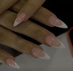 a woman's hands with white and pink nails