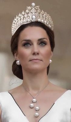 a woman wearing a tiara and pearls