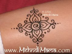 a woman's arm with a henna tattoo on it