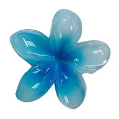 a blue flower shaped object sitting on top of a white surface