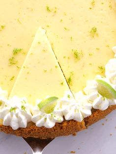 a piece of cheesecake on a white plate with a silver serving utensil