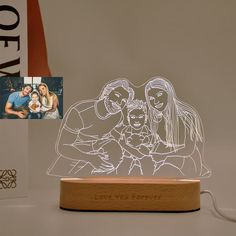 a wooden stand with a laser light on it and an image of two people holding a baby