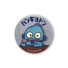 a button with an image of a blue monster eating something