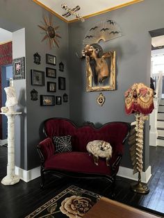 a living room filled with furniture and pictures on the wall