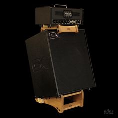 an amp is sitting on top of a wooden stand