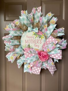 a mother's day wreath on the front door with pink flowers and polka dots