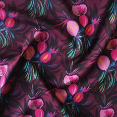 the fabric is very colorful and has pink flowers on it, as well as green leaves