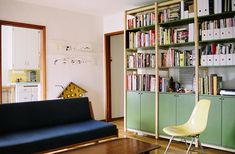 a living room filled with furniture and bookshelves