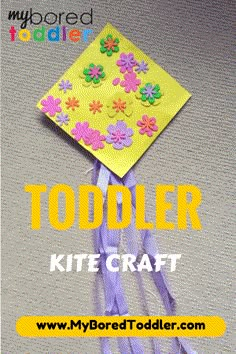 a paper kite with flowers on it and the words toddler kite craft