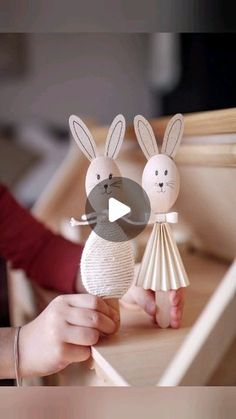 two paper rabbits are on top of each other