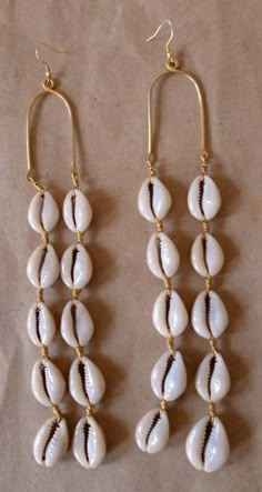 "Wholesale cowrie shell earrings are simple and light in weight.  Gift for loved ones and resellers. Simple and light in weight. Very comfy on any occasion. The earrings are made with a lot of love.  Listing for five pairs of earrings. Dimensions 7\" long Custom orders are welcome. For more earrings; https://www.etsy.com/listing/695802374/african-earrings-beaded-earrings-white?ref=shop_home_active_3 Dhl shipping express. Thankyou." Handmade White Shell, Handmade Shell Hoop Earrings, Handmade Hoop Earrings With Shell, White Shell-shaped Cowrie Shell Earrings, White Cowrie Shell Earrings For The Beach, White Cowrie Shell Earrings, Bohemian White Cowrie Shell Earrings, Seashell Jewellery, Earrings Space