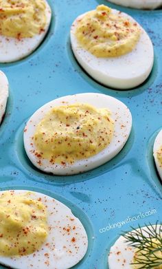 deviled eggs with mustard and seasoning in a muffin tin