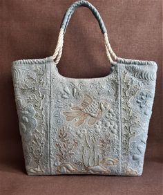 a handbag with an embroidered design on it