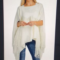 Women’s Soft Poncho With Fringe Cream 100% Acrylic One Size Casual White Poncho With Batwing Sleeves, Chic White Winter Cape, Oversized White Poncho Cape, Oversized White Cape Poncho, Chic White Cape For Spring, White Fringe Tops For Fall, Oversized White Cape, Chic White Poncho For Fall, Chic White Fall Poncho