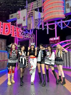 girls'generation perform on stage in front of neon signs at the end of their performance