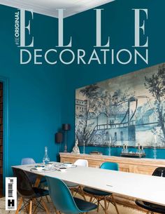 a magazine cover with blue walls and artwork on the wall, including a dining table