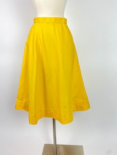 "Late 1970s Yellow A Line Skirt Front slide button closure, see photos A line shape Waist: 24\" Hips: 42\" Length: 28\" Opening: 32\"/33\" Labels/Materials: Feels like a polyester cotton blend or polyester and synthetic blend - Metal slide hook buttons Excellent vintage condition, just one tiny pin dot" Daywear A-line Lined Skirt, Classic A-line Skirt For Summer, Classic A-line Summer Skirt, Yellow A-line Pleated Skirt, Retro A-line Workwear Bottoms, Yellow Retro Skirt With Relaxed Fit, Classic Full Skirt For Summer, Yellow A-line Bottoms For Spring, Retro Knee-length Skirt For Summer