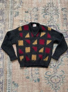 "Vintage McLaren quality menswear sweater. Brushed wool. Charcoal grey with red and yellow shapes. Vneck. Size 40. 100% pure wool. Measurements: Chest- 21.5\" Shoulders- 18.5\" Sleeves- 23\" Length- 22\" All measurements taken flat and not doubled." Vintage Mclaren, Check Coat, Hand Felted, Red And Yellow, Trucker Jacket, Wool Cardigan, Charcoal Grey, Vintage 70s, Vneck Sweater