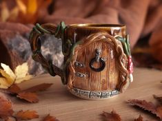 a coffee mug with an image of a tree house on the inside is surrounded by leaves