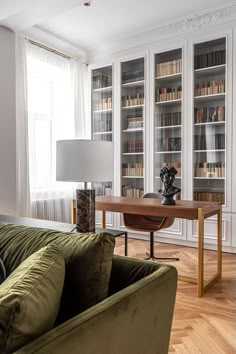 a living room filled with furniture and bookshelves