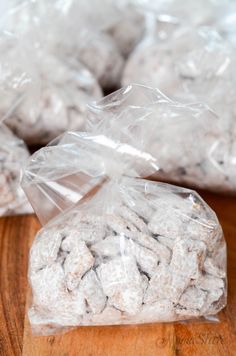 two bags of cookies sitting on top of a wooden table