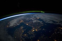 the earth is lit up at night from space