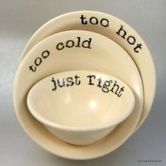 three white bowls with words written on them