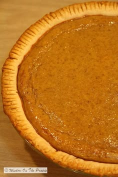 a pumpkin pie sitting on top of a wooden table