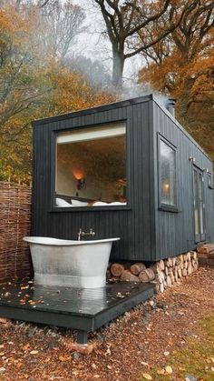 a tiny house with a tub in the yard