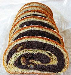 slices of chocolate swirl bread on a white tablecloth lined up in a row, ready to be eaten