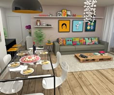 a living room filled with furniture next to a dining table and tv set on top of a hard wood floor