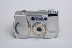 a silver camera sitting on top of a white table