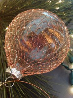 an ornament hanging from a christmas tree with lights on it's branches