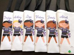 four personalized wine bags with girls in cheerleader outfits and name tags on them