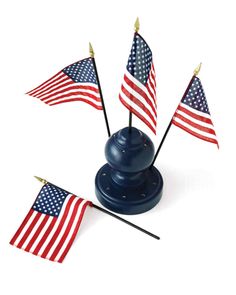 three american flags on top of a blue stand with two black sticks sticking out of it