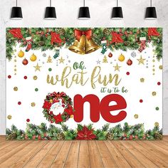 an image of a christmas themed backdrop with bells and wreaths on the front, which reads oh what fun it's to be one