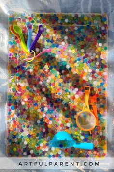 there are many different colored objects on the glass plate that is made out of confetti