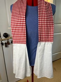 a red and white checkered scarf on a mannequin