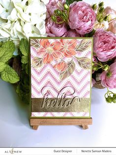 a close up of a card with flowers in the background