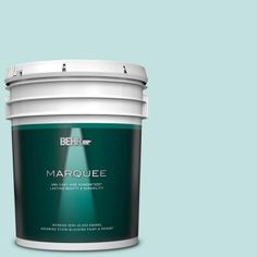 the behr color marquee paint is shown in an open bucket on a gray background