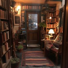 a room filled with lots of books on shelves and a door leading to another room