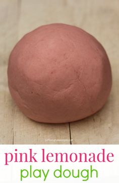 a pink lemonade play dough sitting on top of a wooden table with the words pink lemonade play dough