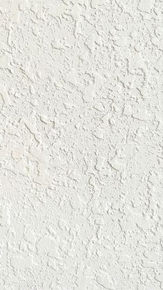 an old white stucco wall textured with paint