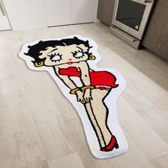 a rug with a woman's face on it in the middle of a kitchen