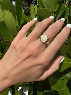 Vintage 9k Coin Signet Ring Ornate Shoulders Description: This vintage 9k coin signet ring features ornate shoulders, adding a unique touch to your collection. Sized at 6 and weighing 2.44g, the coin measures 11.8mm and showcases British hallmarks. This piece is perfect for adding a statement to any outfit. As with all our pieces, this ring is a rare find--once it's gone, it's gone. Choosing this piece helps you stand out from the crowd while supporting sustainable practices. Why You'll Love It:      Unique Design: The ornate shoulders and coin add a distinct, stylish element.      Perfect for Stacking: The design makes it versatile for stacking with other rings.      Dainty and Slim: The delicate design is ideal for a chic, minimalist look.      Rare and Exclusive: Stand out from the rest Rings Dainty, Sustainable Practices, Delicate Design, Gold Coins, Stackable Rings, Signet Ring, Statement Rings, Unique Pieces, Solid Gold