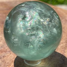 a glass ball sitting on top of a wooden table